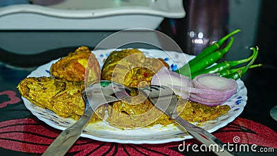 fish curry,onion,chilli on a plate on the dining table. Stock Photo